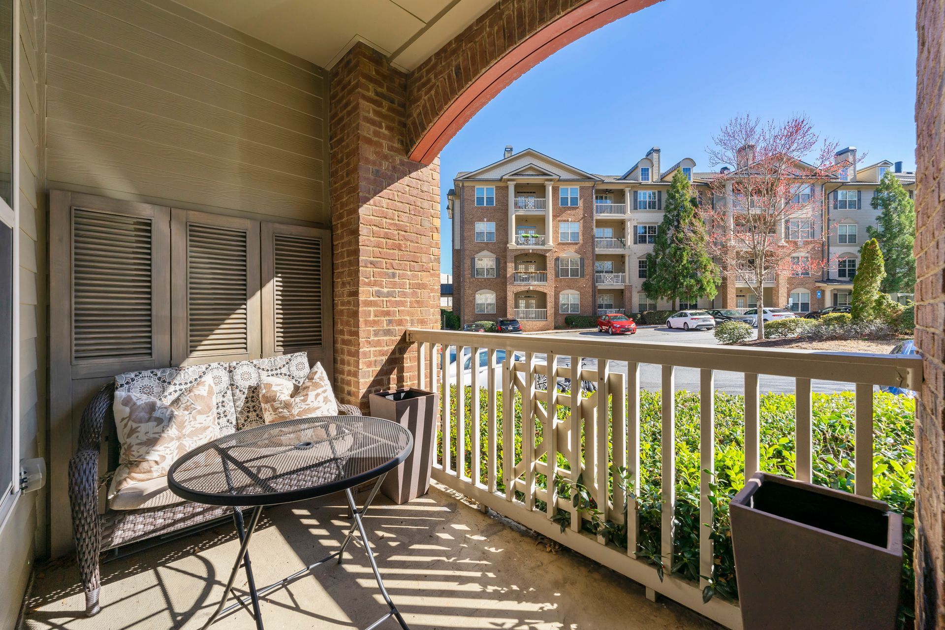 There is a balcony with a couch and a table on it.