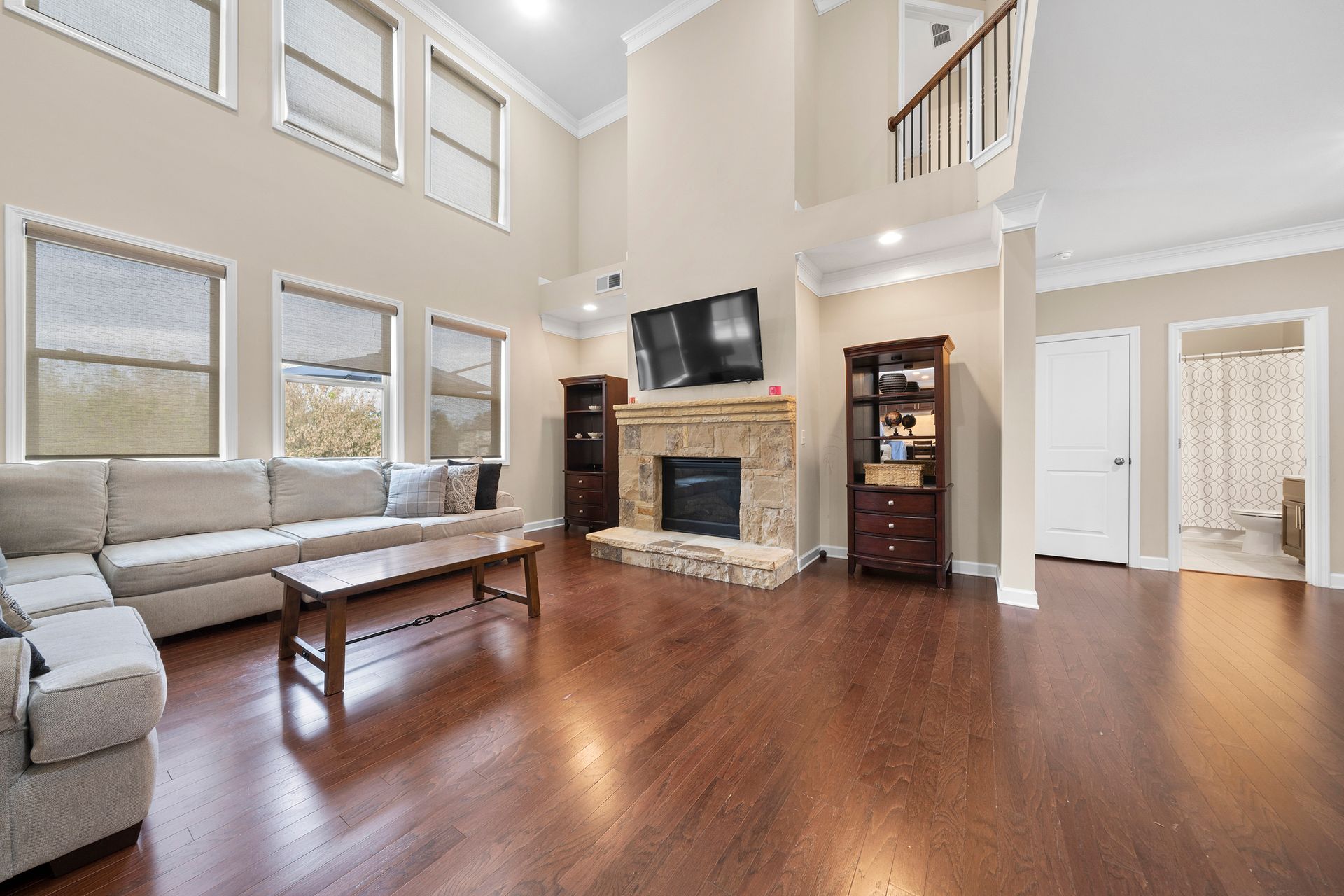 A living room with a fireplace , couch , coffee table and television.