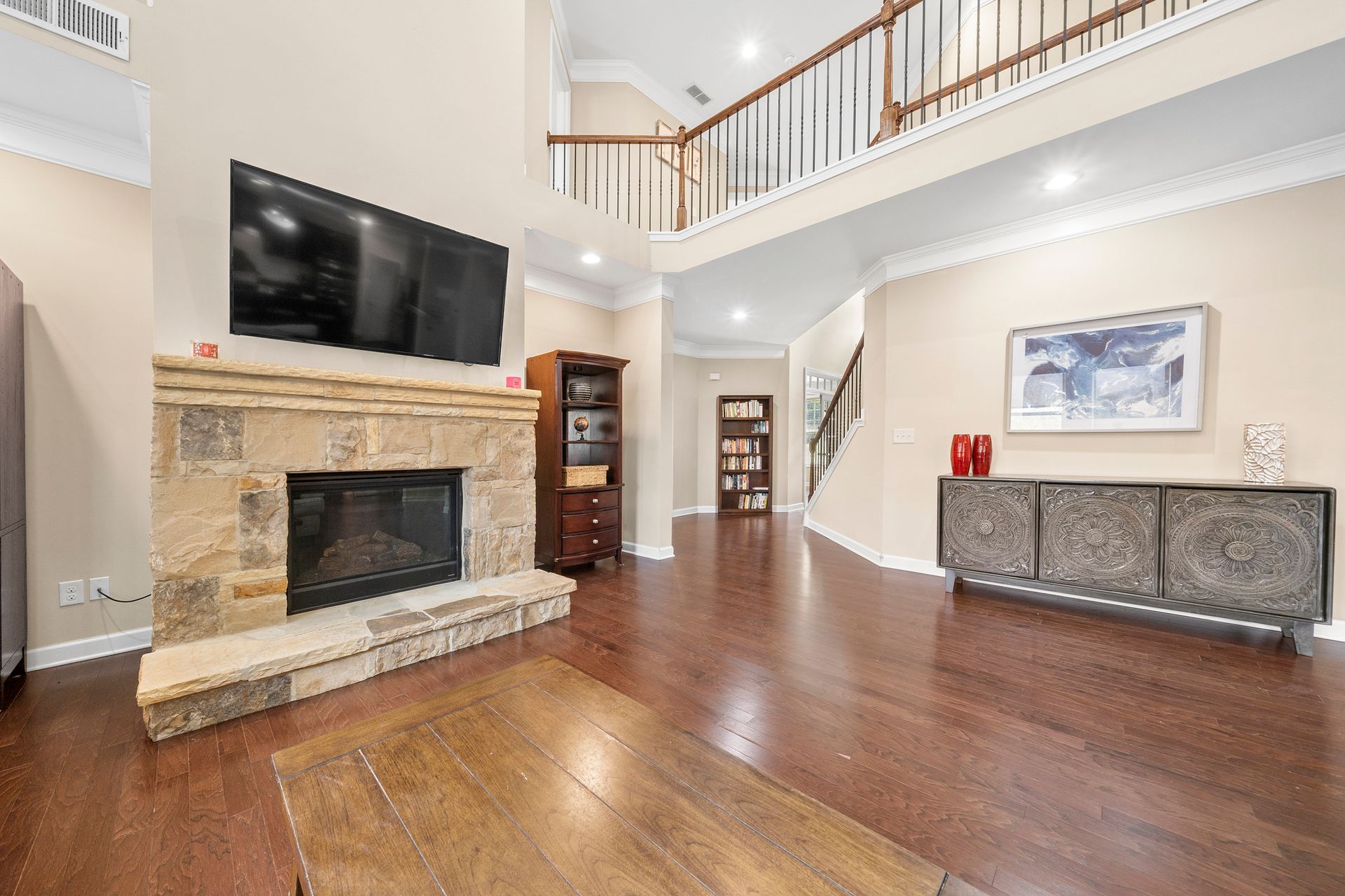 A living room with a fireplace and a flat screen tv.