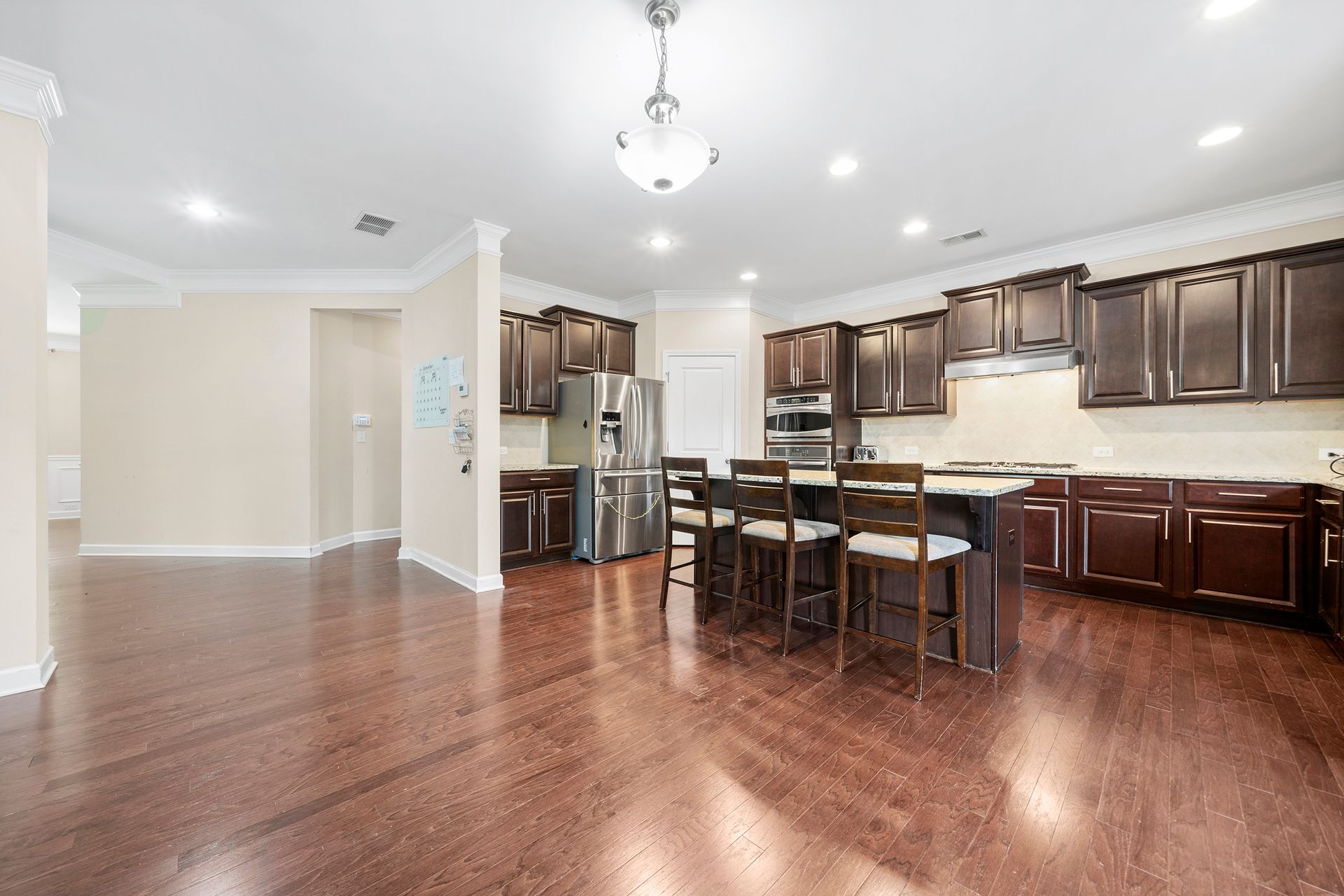 A kitchen with stainless steel appliances and wooden cabinets.