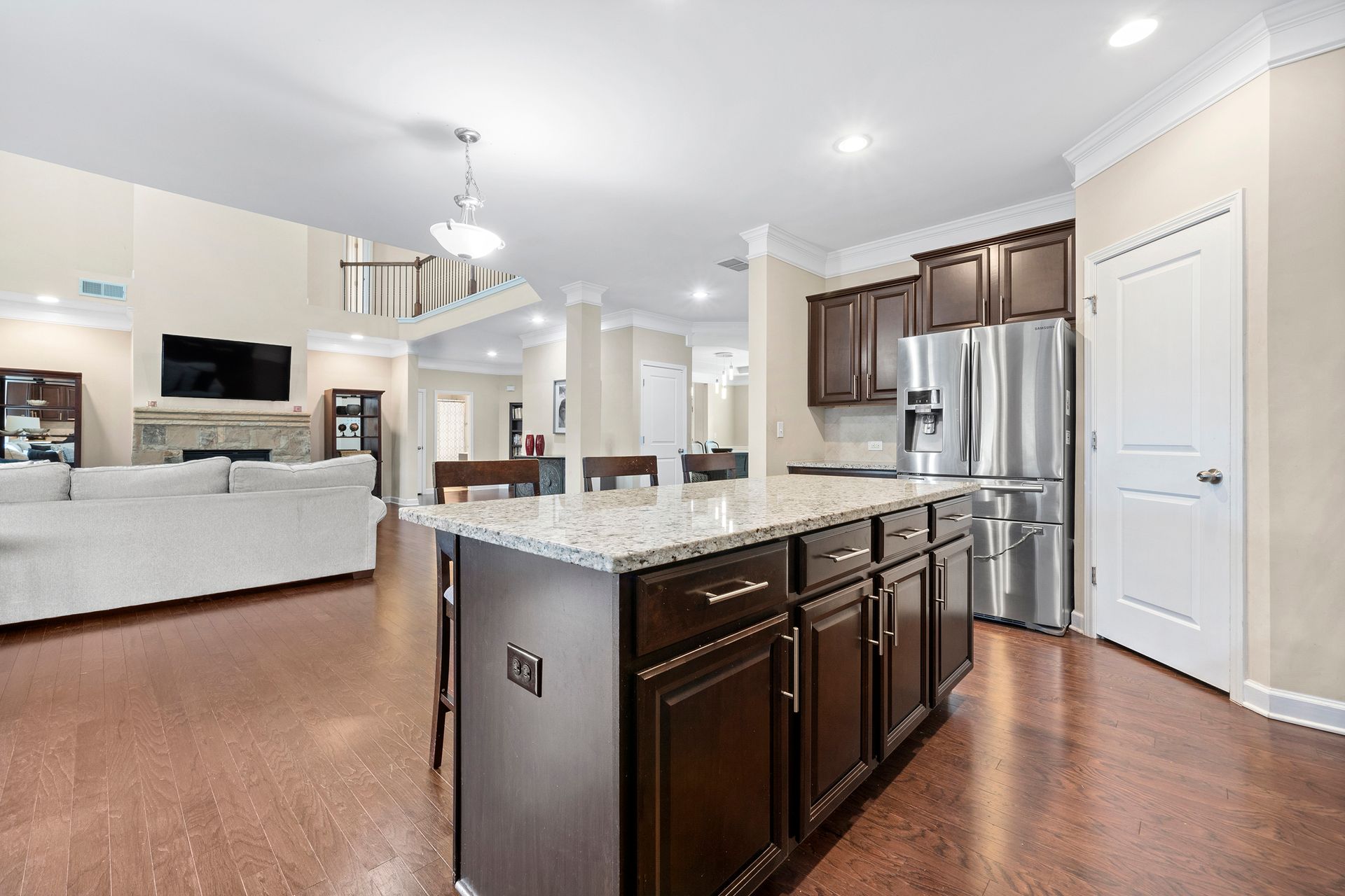 A kitchen with a large island and stainless steel appliances.