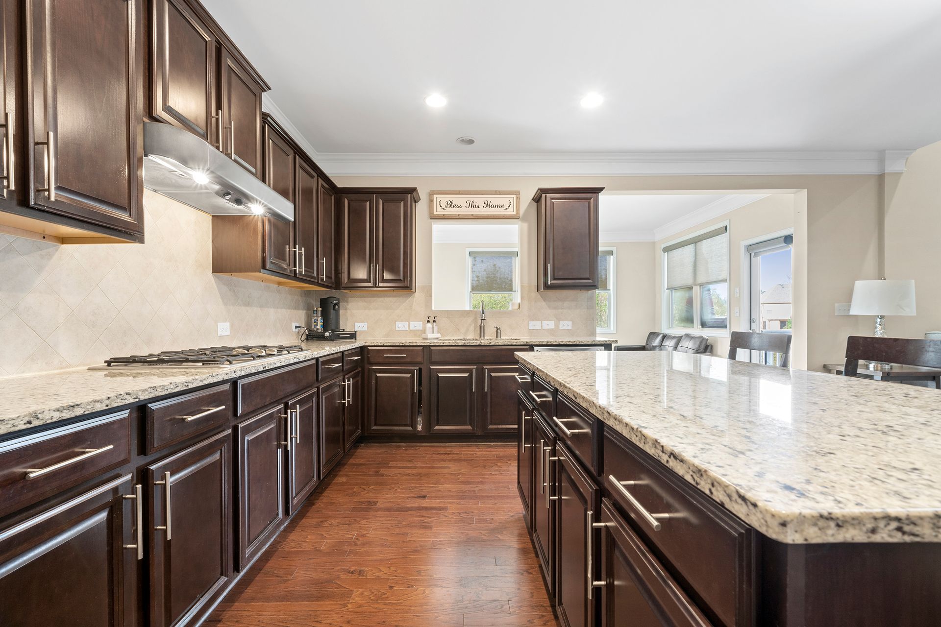 A kitchen with brown cabinets and granite counter tops.