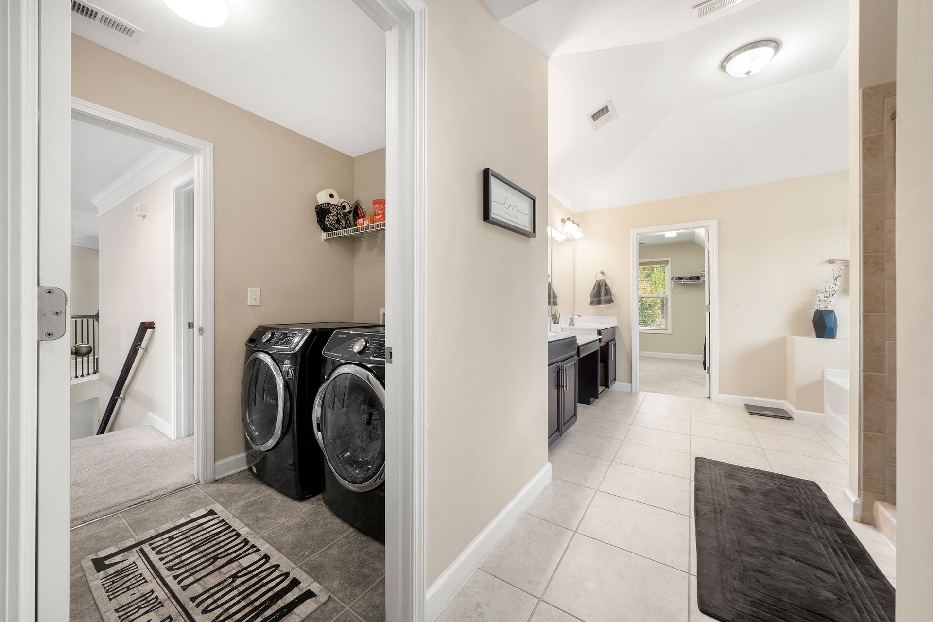 A laundry room with a washer and dryer in a house.