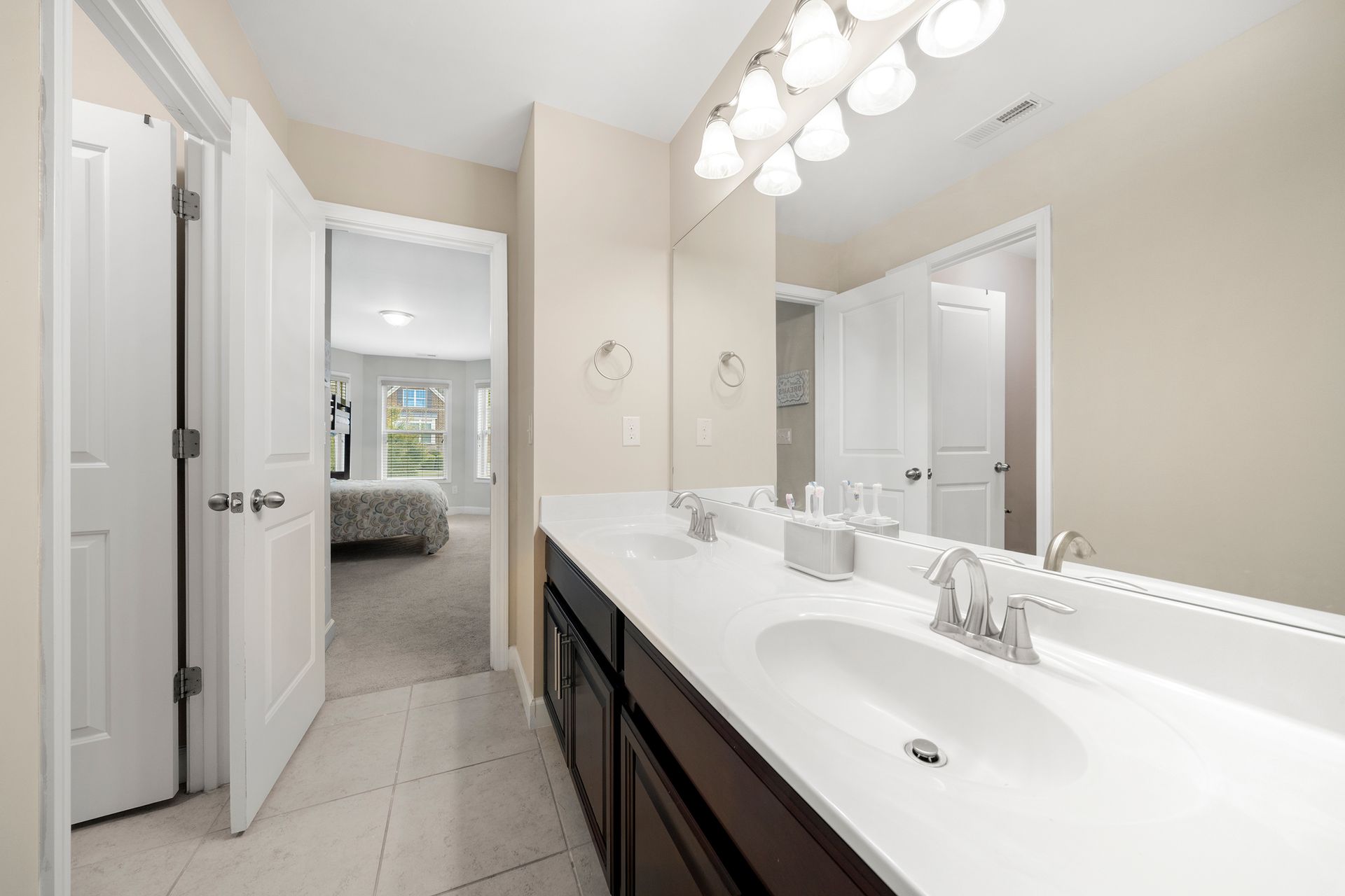 A bathroom with two sinks and a large mirror.