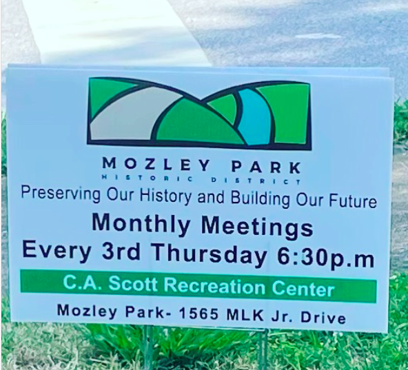 A sign for mozley park advertising monthly meetings