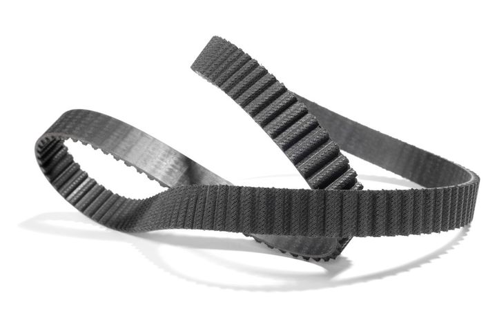 A man wearing gloves is working on a clutch disc
