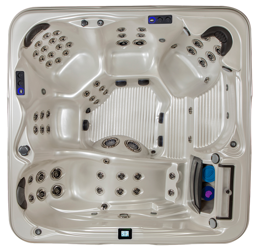 Overhead view of a beige hot tub with multiple jet configurations, seats, and controls.