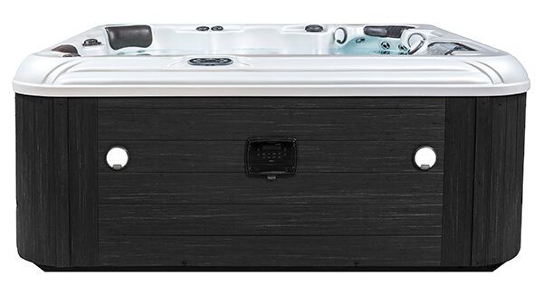 Hot tub with dark gray exterior, white trim, and jets visible.