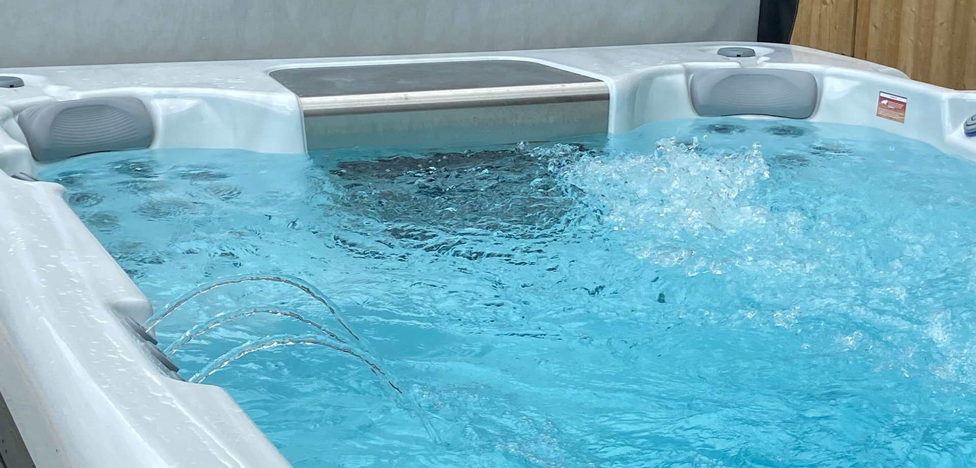 Bubbling blue water in a white hot tub.