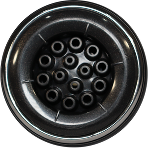 Black circular object with a central array of cylindrical holes, surrounded by a wider rim.