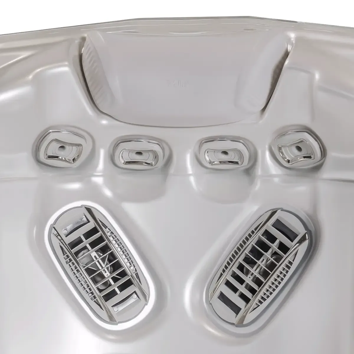 Close-up of a silver hot tub with multiple jets. Four small square jets are above two larger, angled, rectangular jets.