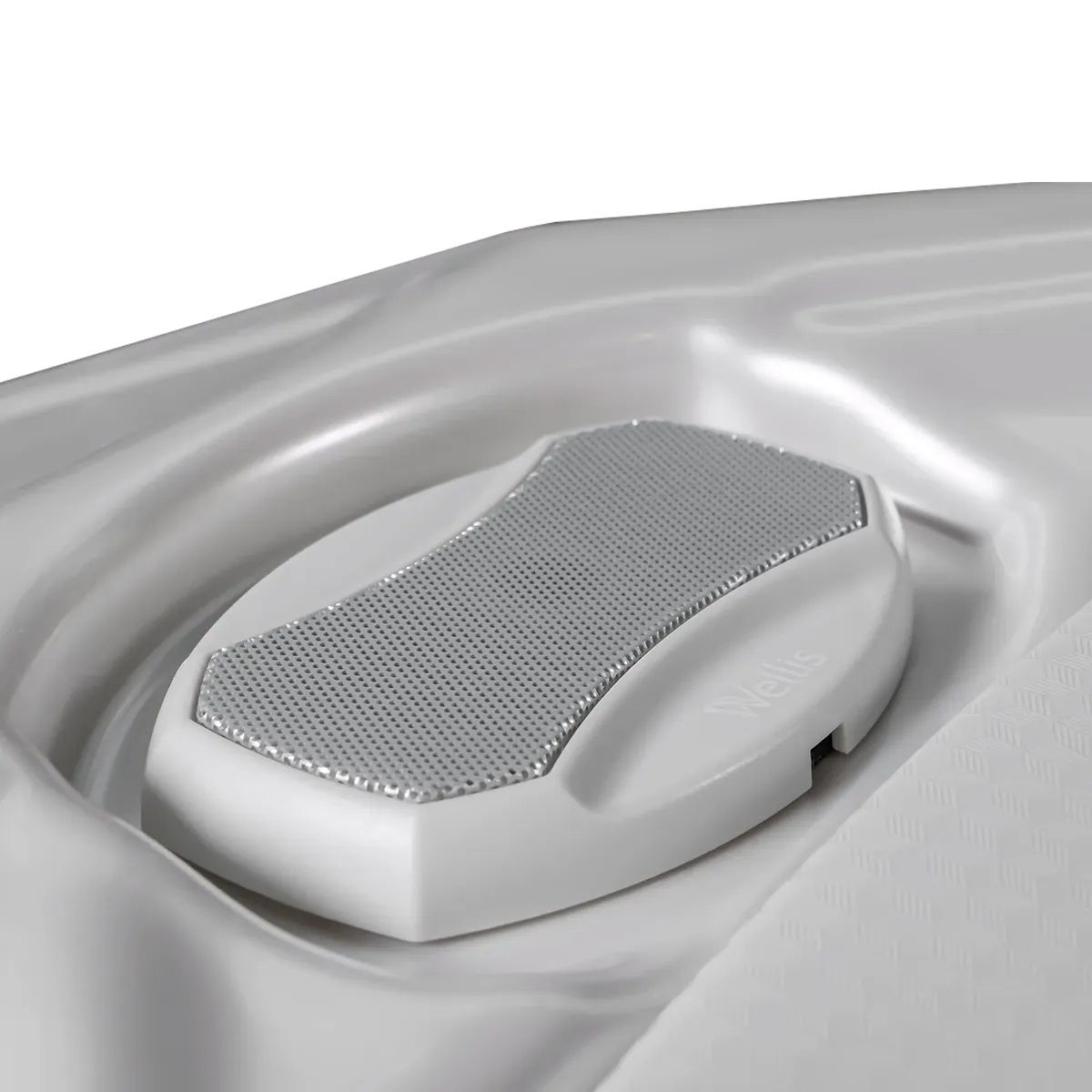 White foot massage pad recessed in a white hot tub. The pad has a textured gray surface.