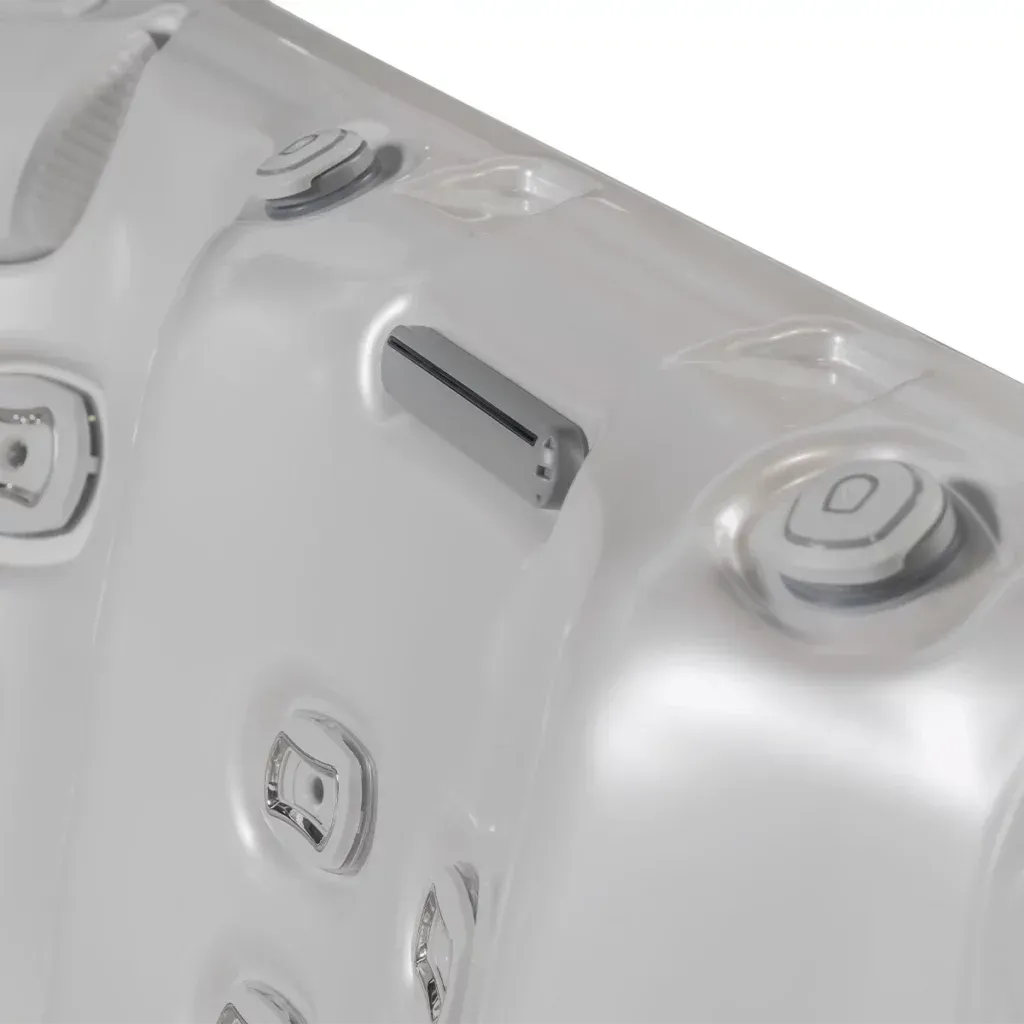Close-up of a white hot tub interior, with jets and control panel.