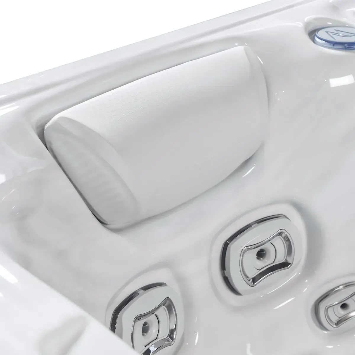 White hot tub with a headrest and chrome jets.