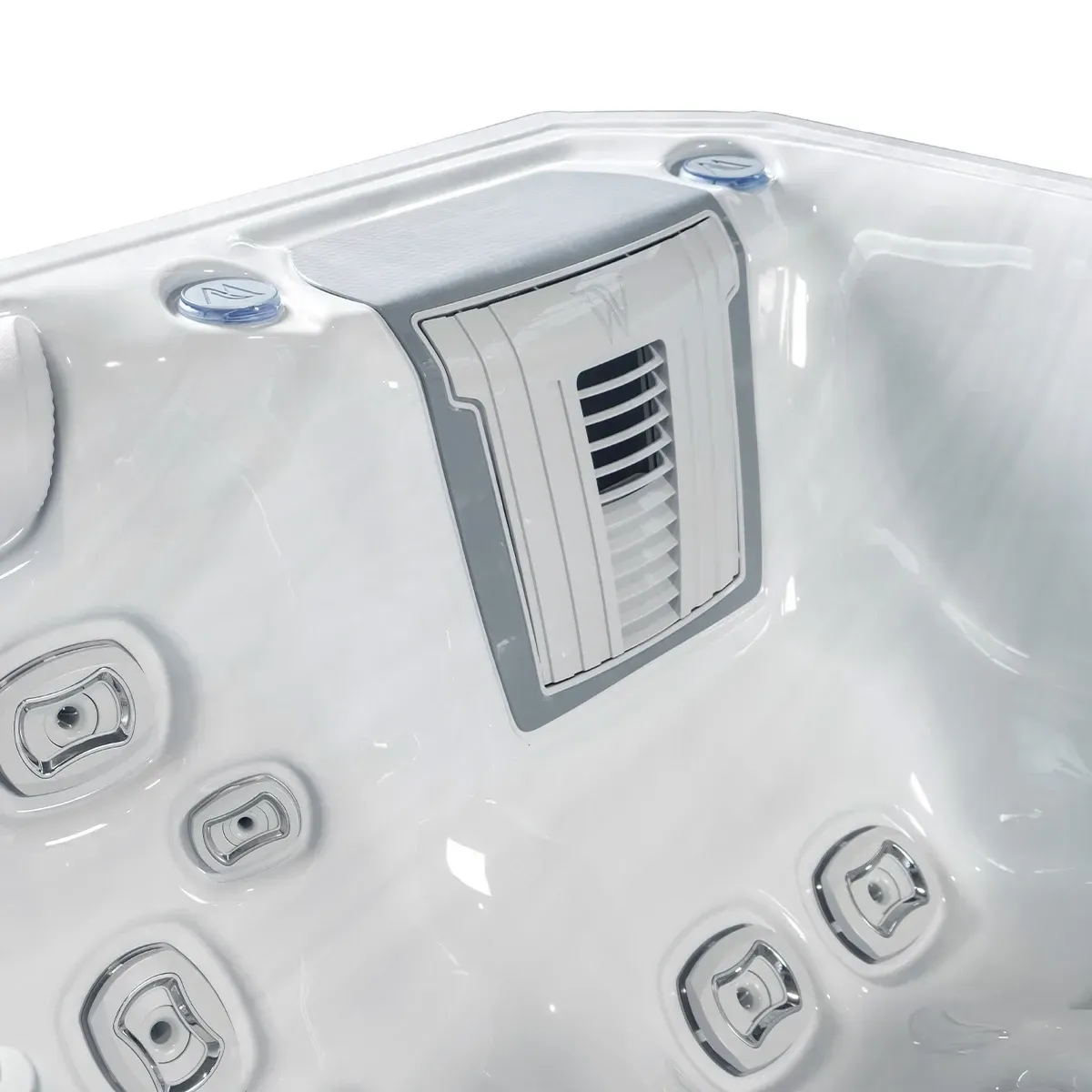Close-up of a white hot tub interior, featuring jets and a vent in the side.