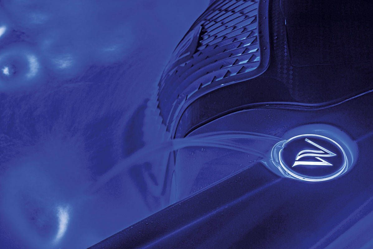 Blue-lit detail of a device, possibly a hot tub or similar. Features a logo and water flow.