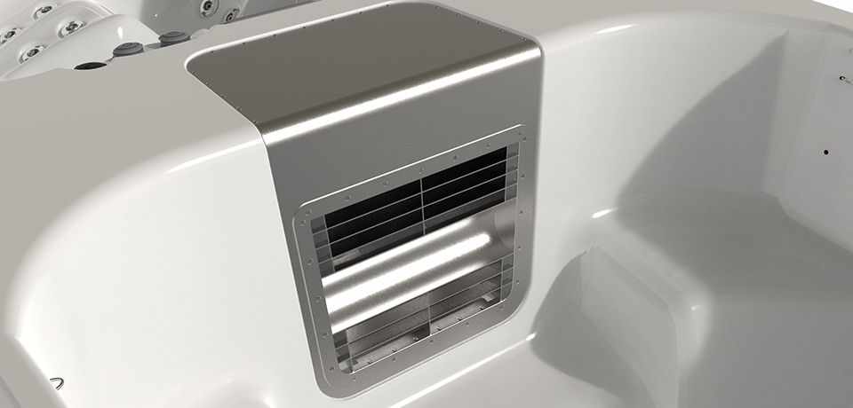 Close-up of a white hot tub interior, focusing on a rectangular vent with a metal cover.