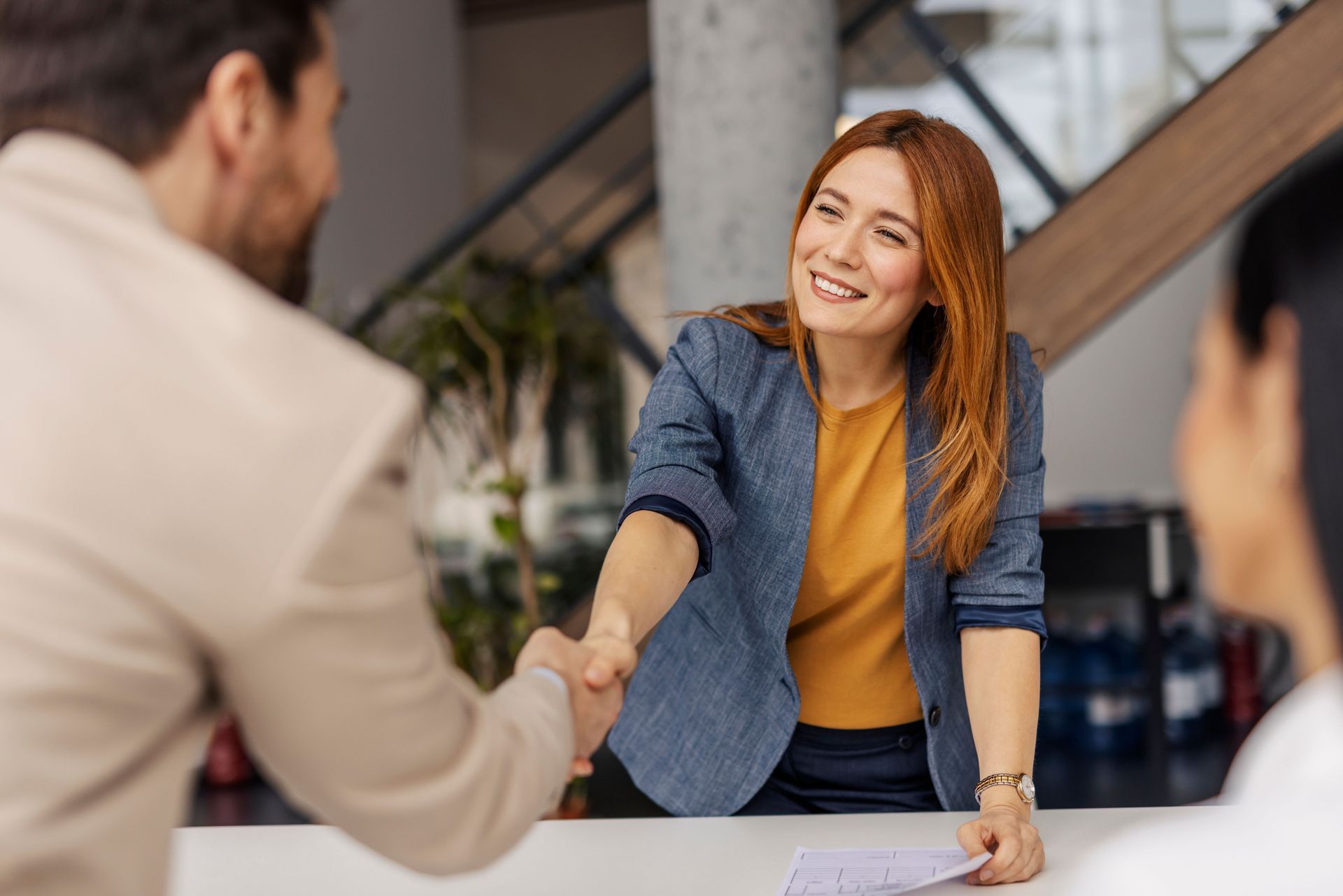 Woman in Blazer Shakes Hands With a Man — Into Finance Lending Solutions in Pacific Palms, NSW