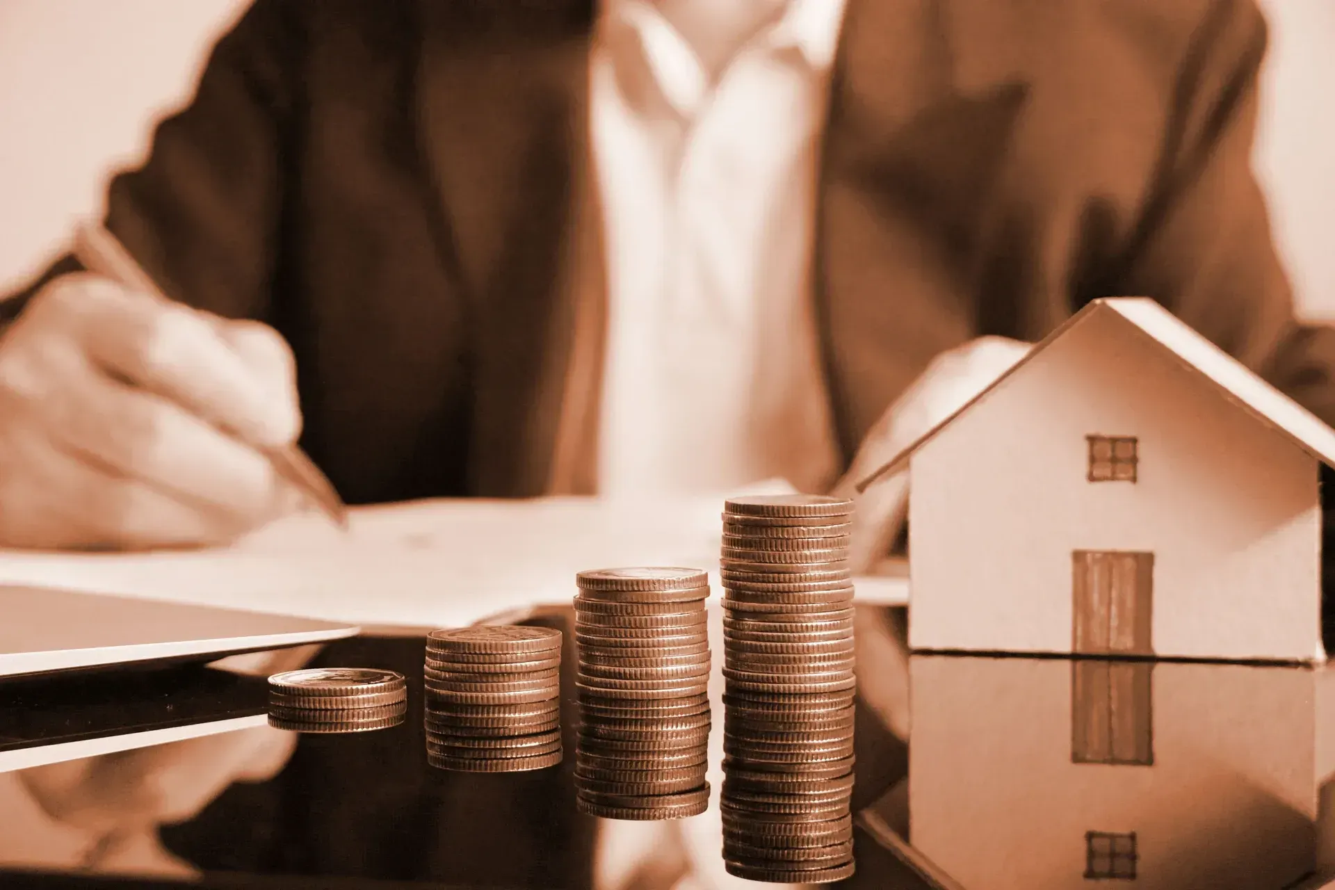 Stacks of Coins Growing Next to a Model House — Into Finance Lending Solutions in Coomba Bay, NSW