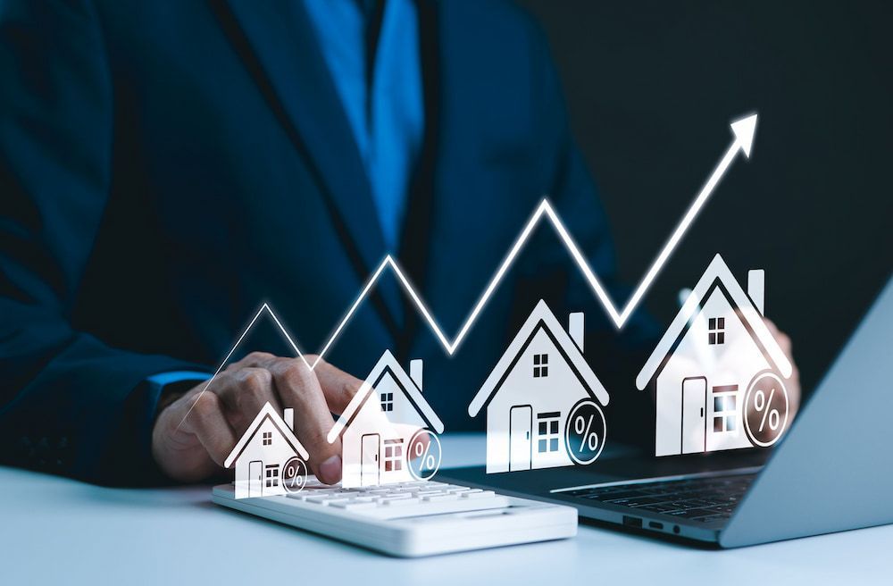 Man in Suit With Calculator and Laptop; Houses — Into Finance Lending Solutions in Coomba Bay, NSW