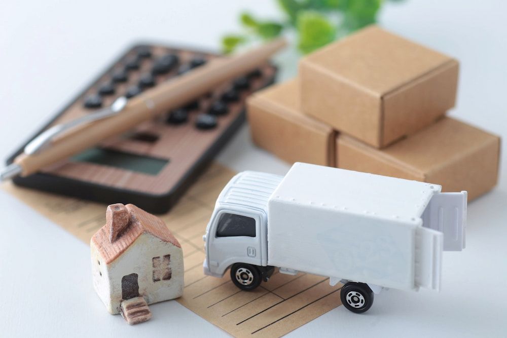 Toy Truck With Opened Back, Boxes, a House Model, Calculator, and Pen — Into Finance Lending Solutions in Coomba Bay, NSW