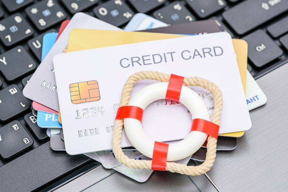 Credit Cards With a Life Preserver on a Laptop Keyboard — Into Finance Lending Solutions in Coomba Bay, NSW