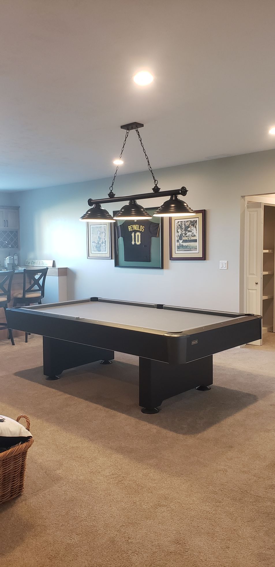 There is a pool table in the middle of the room.