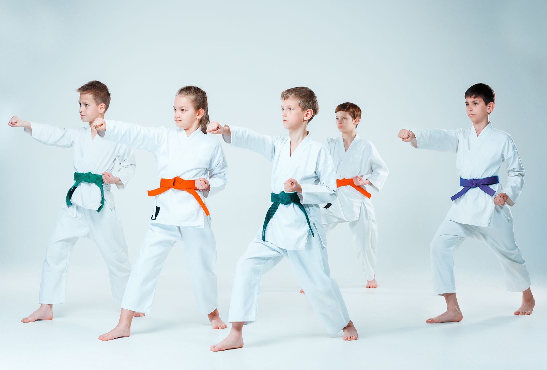 group of boys and girl fighting at aikido