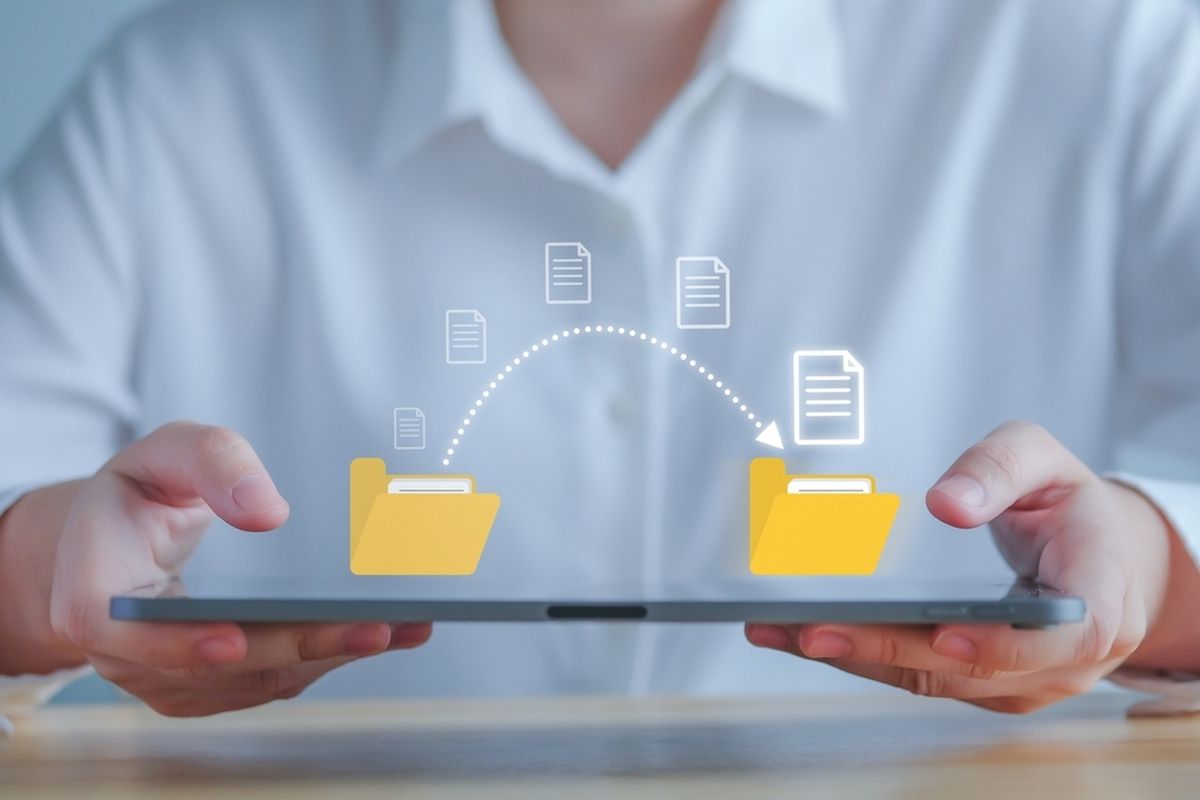A Person Is Holding A Tablet With A Folder Icon — Black Label I.T. in Garbutt, QLD