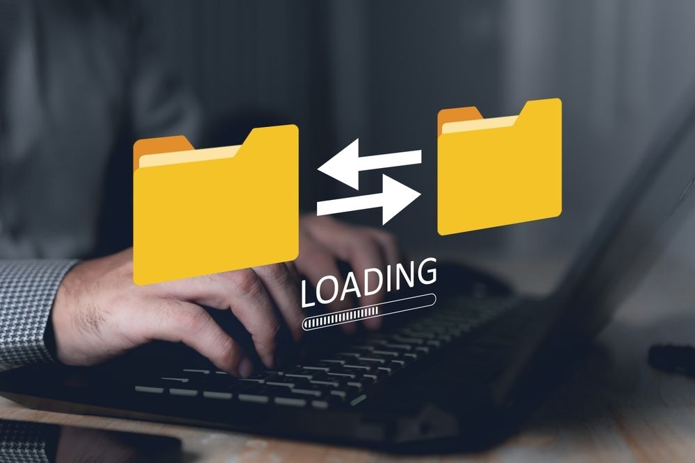 A Person Is Typing On A Laptop With A Loading Icon On The Screen — Black Label I.T. in Garbutt, QLD