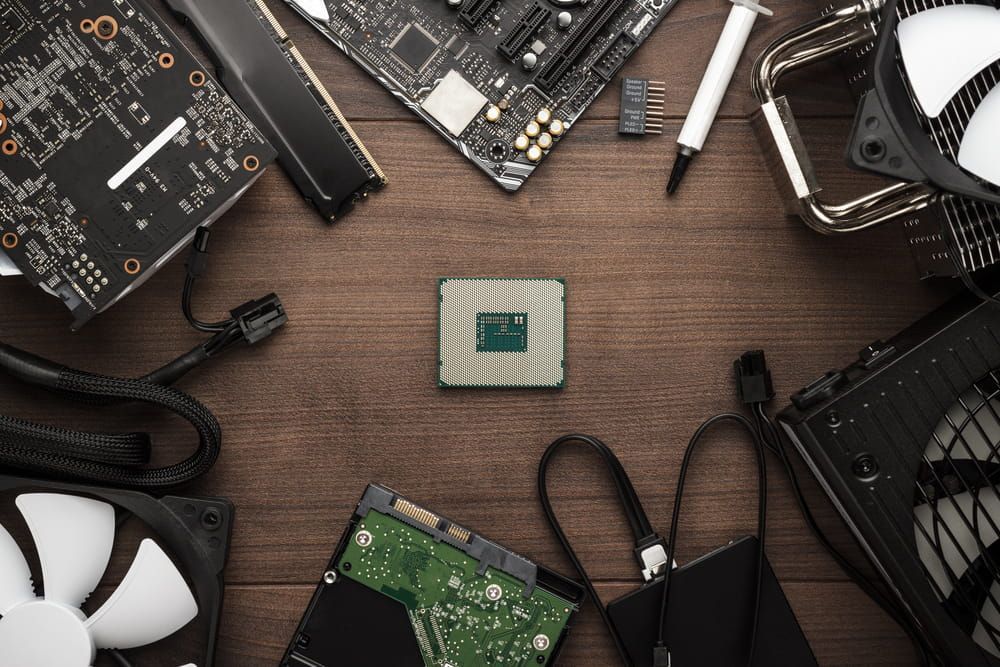 A Bunch Of Computer Parts Are Sitting On A Wooden Table — Black Label I.T. in Garbutt, QLD