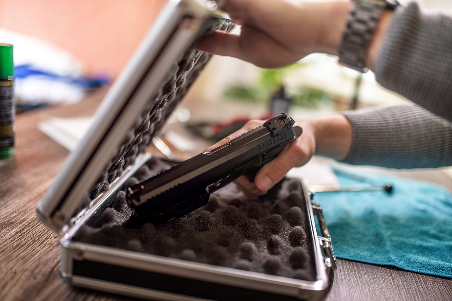 A person placing a handgun in a case