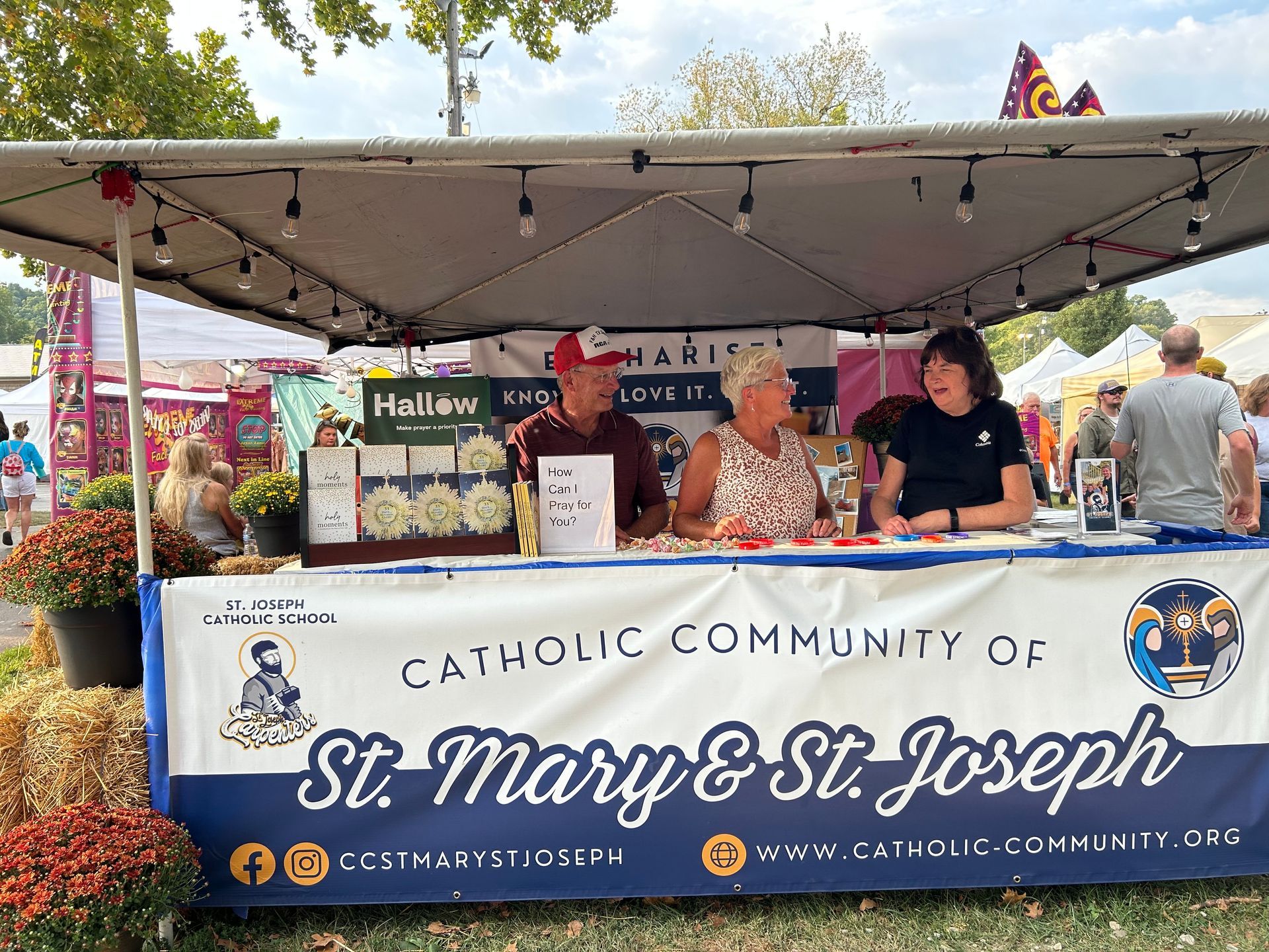 Two staff members smiling in a restaurant kitchen, one holding food and giving a thumbs-up.