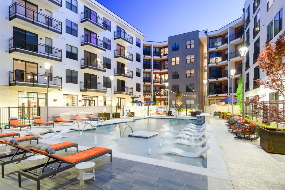 a large apartment building with a swimming pool in the middle of it .