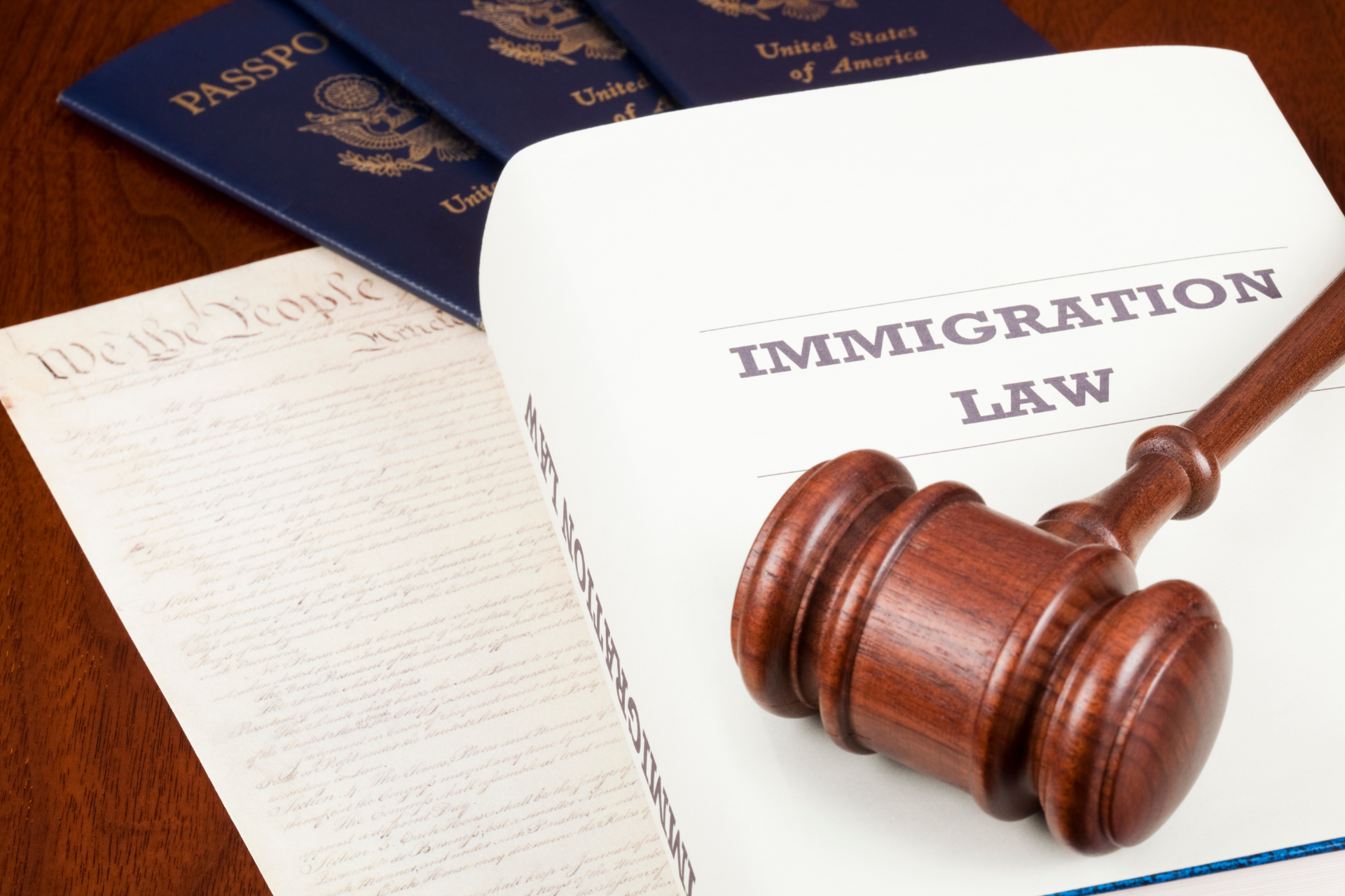 A judge 's gavel sits on top of a piece of paper that says immigration law