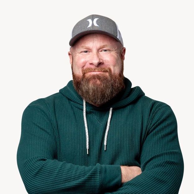 a man with a beard wearing a hurley hat