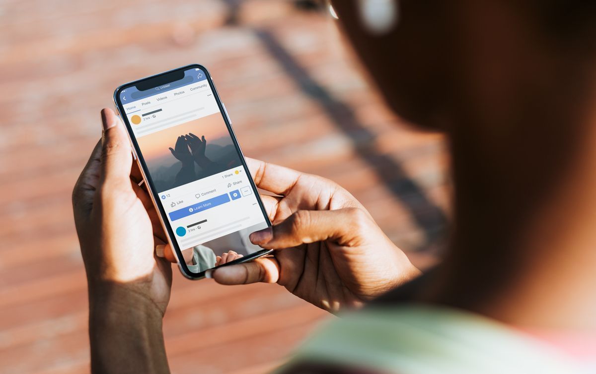 A person is holding a cell phone in their hands.