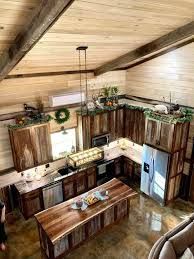 Rustic kitchen with wood cabinets, island, and concrete floors, overhead view.