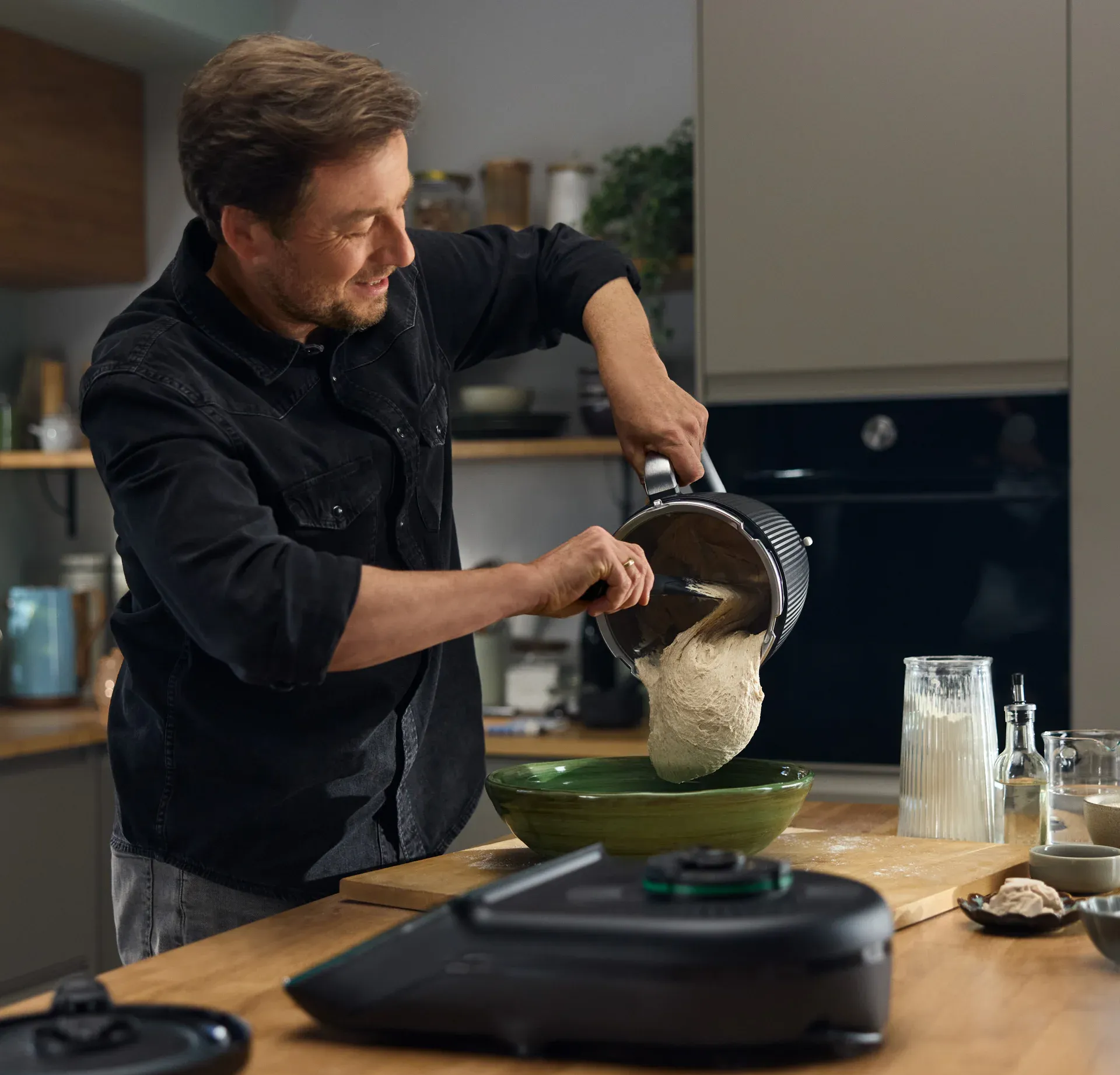 MAN Pouring Batter From a Mixing Bowl Into a Green Bowl — Clare Quintieri Thermomix Consultant in Mareeba, QLD