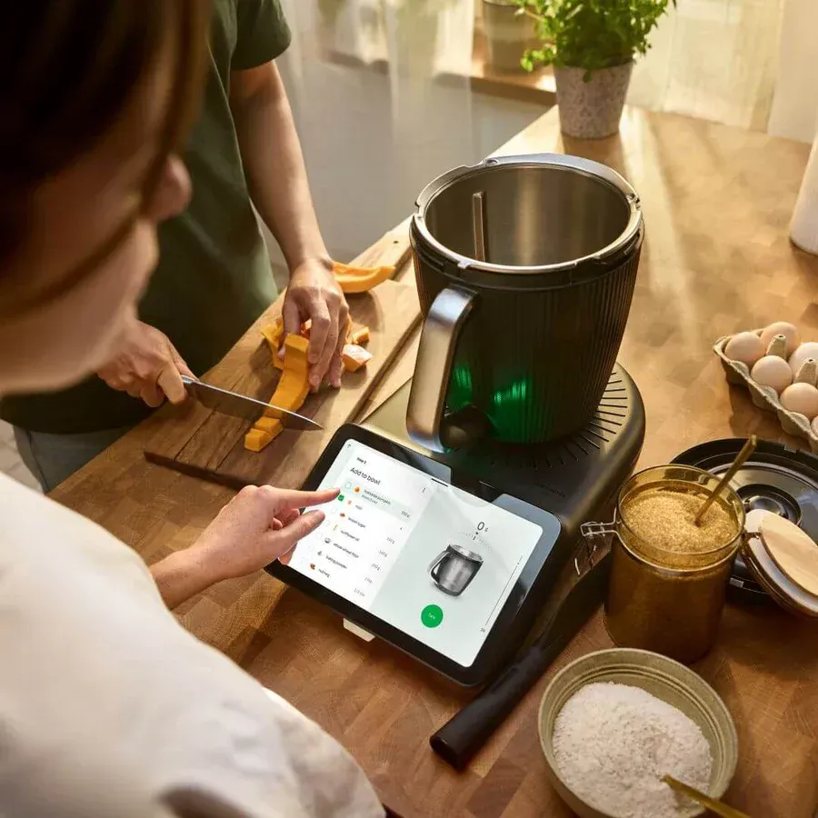 Person Using a Tablet Beside a Cooking Pot — Clare Quintieri Thermomix Consultant in Mareeba, QLD