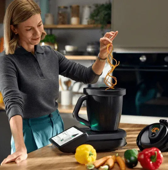 Woman Adding Pasta to a Blender in a Kitchen — Clare Quintieri Thermomix Consultant in Mareeba, QLD