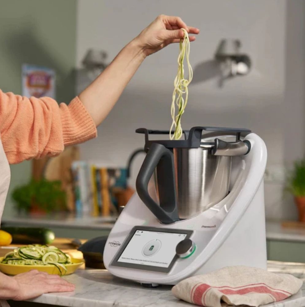 Hand Lowering Spaghetti Into a White Thermomix 6 — Clare Quintieri Thermomix Consultant in Mareeba, QLD