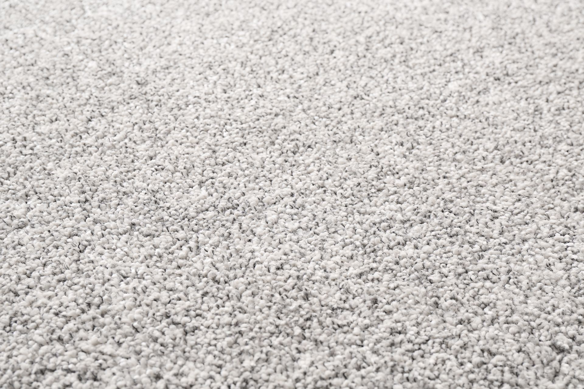 Close-up of a light gray gravel surface with small white stones