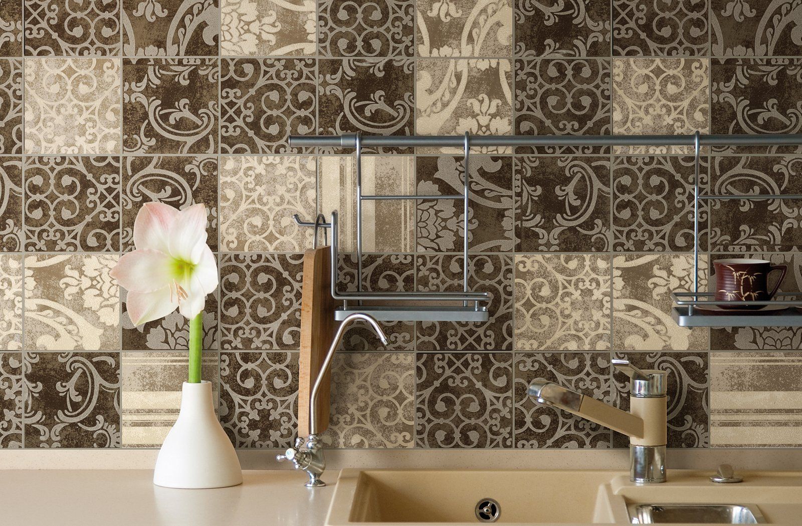 Modern kitchen sink with patterned tile backsplash, white vase with pink flower, and metal faucet