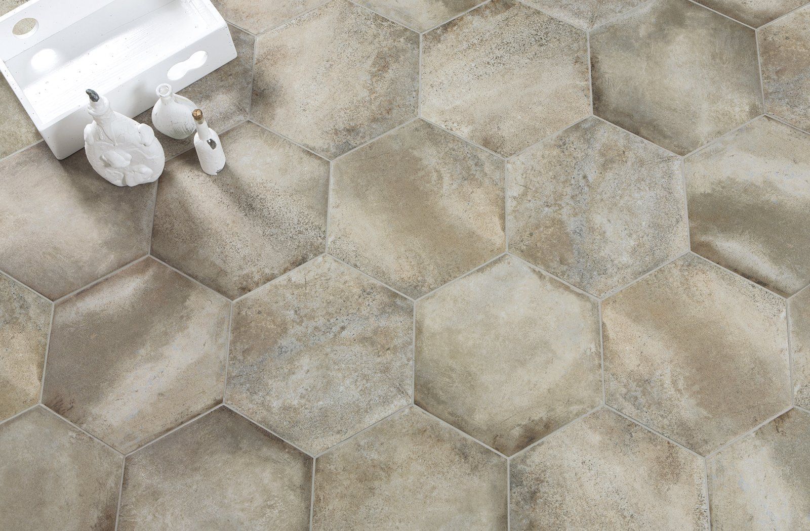 Hexagonal beige stone tiles with a white object in the upper left corner