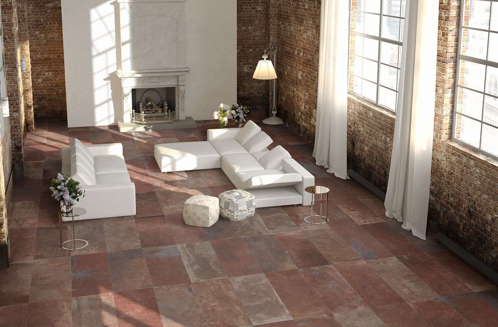 Modern loft living room with white sectional, brick walls, large windows, and fireplace