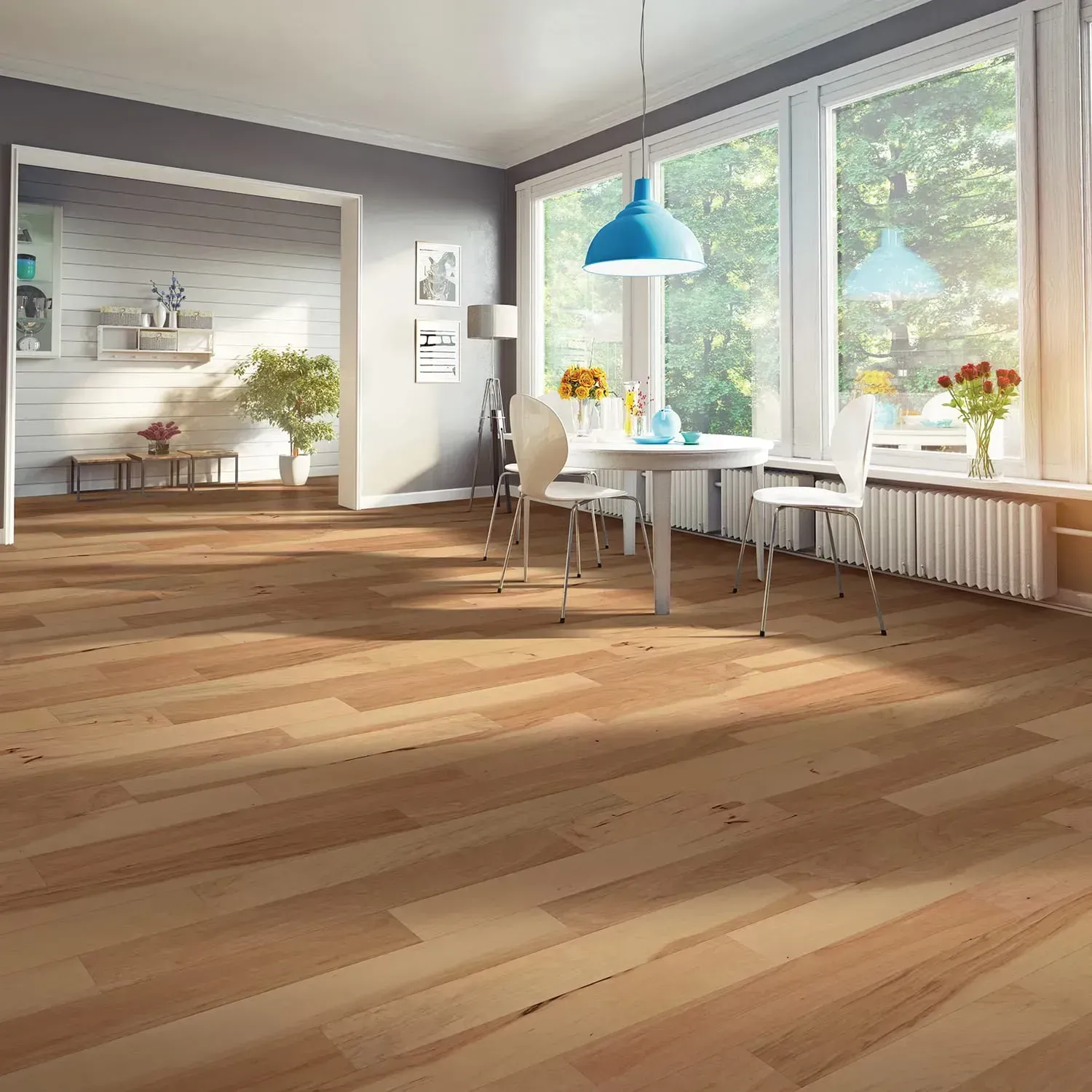 Bright modern dining room with wooden floors, white furniture, blue pendant lights, and large sunlit windows