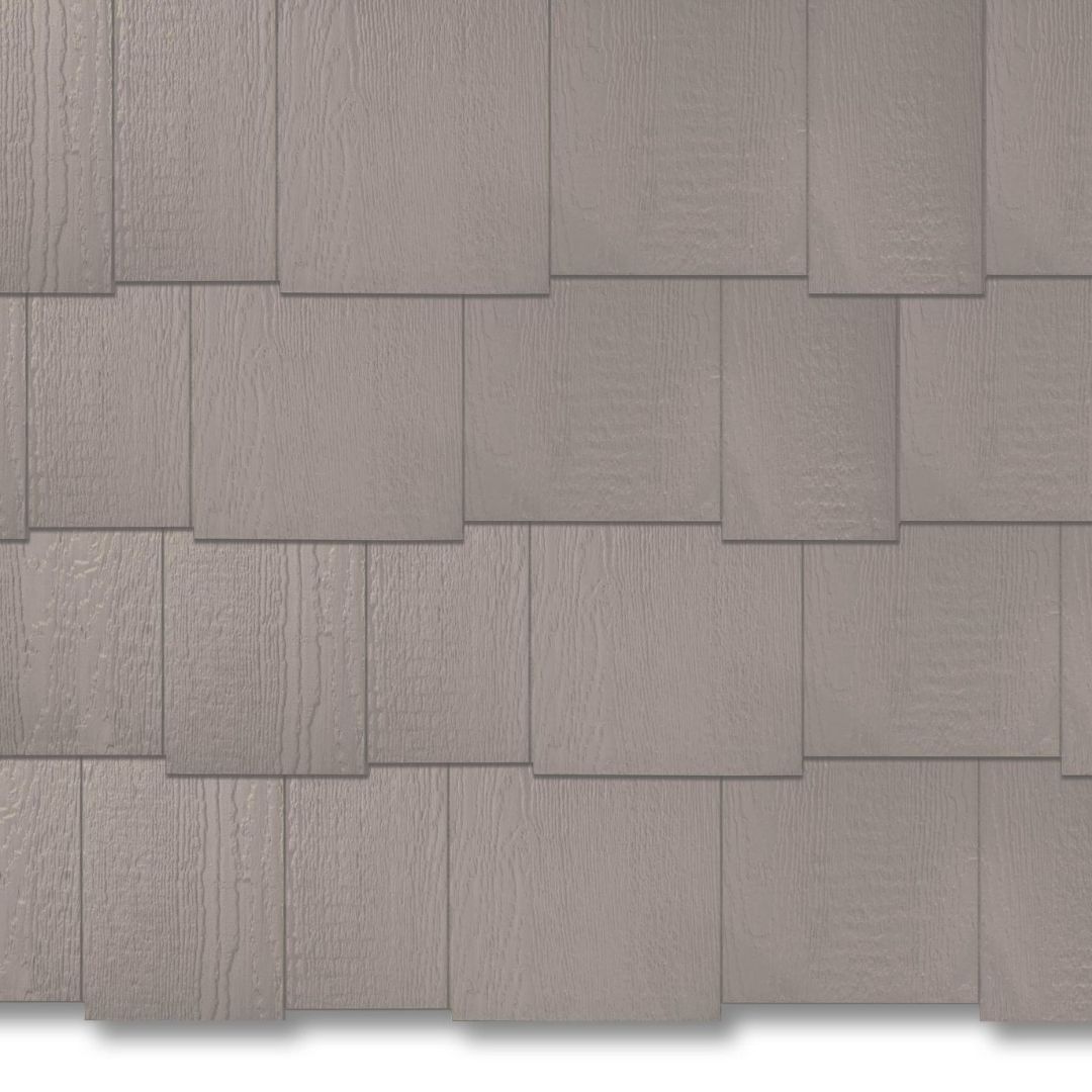Gray overlapping wooden shingles in a repeating wall pattern
