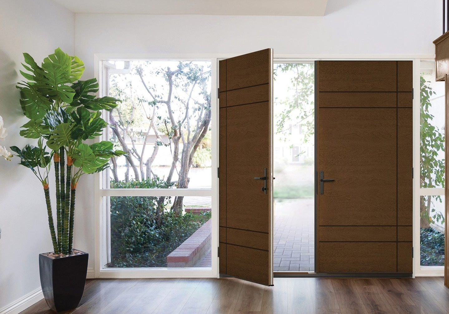 Modern entryway with open wooden doors, large windows, and a potted plant