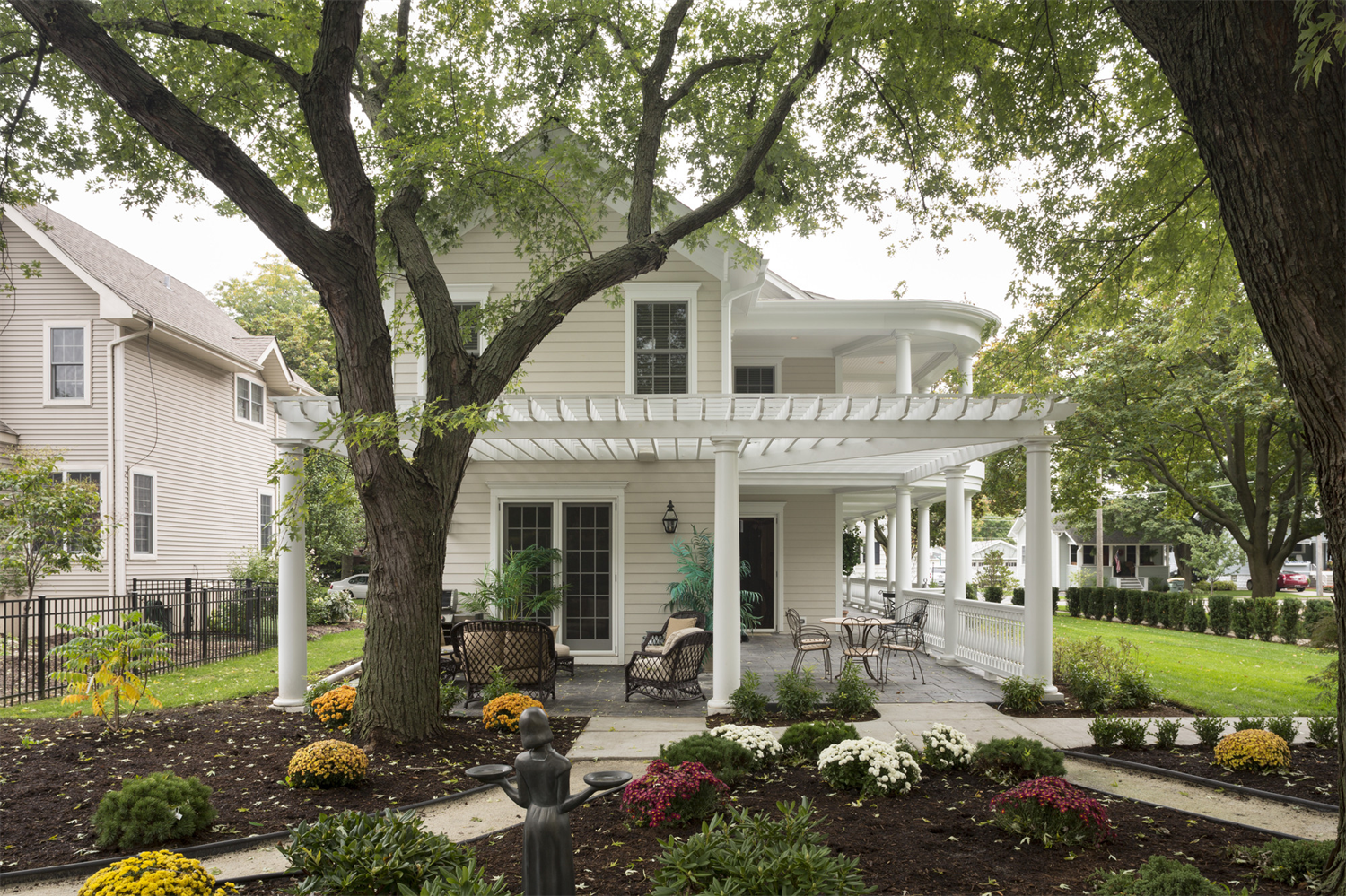 A large white house with a large porch and patio